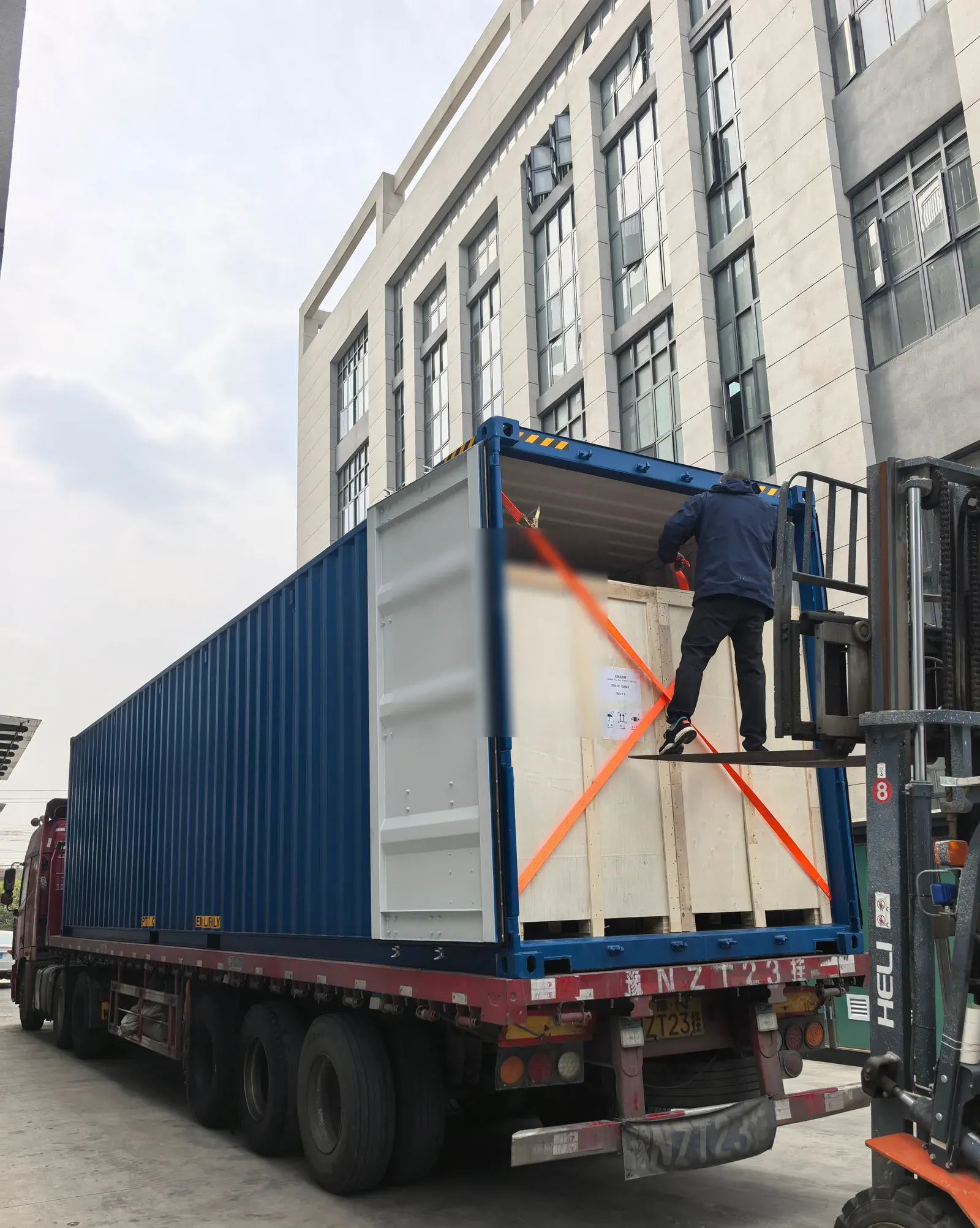 Timber-packed EV charging equipment being secured inside an export container