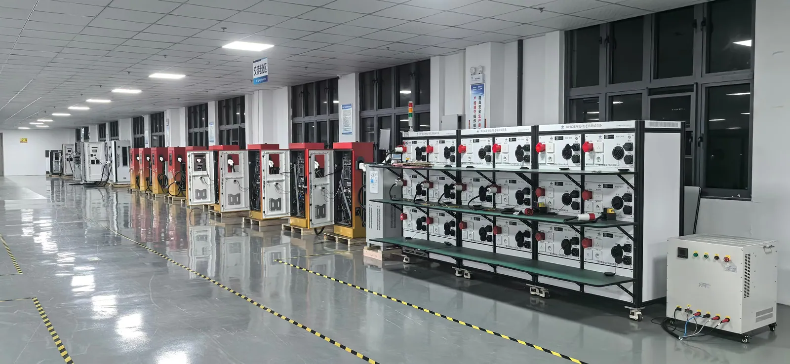 Internal EV charger assemblies organized in marked production workshop lanes
